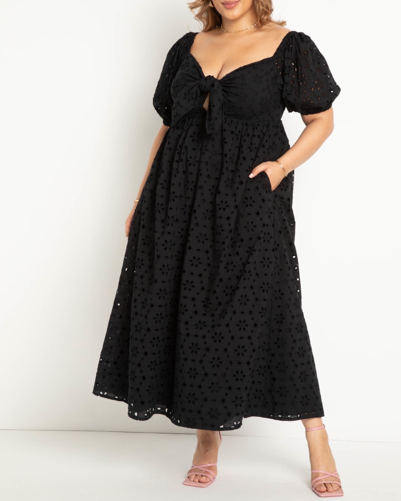 Front of a model wearing a size 22 Eyelet Tie Front Maxi Dress in Black Onyx by ELOQUII. | dia_product_style_image_id:284292